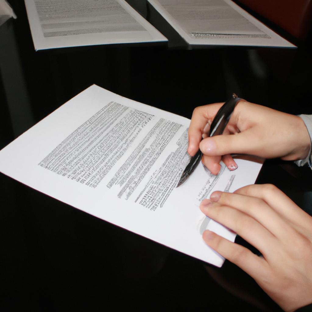 Person reviewing legal documents, writing